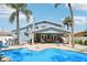 Stunning pool and outdoor living area perfect for relaxing and entertaining with palm trees at 931 Gulf Blvd, Belleair Beach, FL 33786