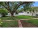 Expansive backyard featuring a large tree, privacy fence, and well-maintained lawn at 9674 104Th Ave, Largo, FL 33773