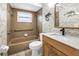 Updated bathroom with a single sink vanity, marble countertop, and tile bathtub with shower at 9674 104Th Ave, Largo, FL 33773