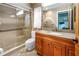 Well-maintained bathroom with a walk-in shower, granite vanity, and tile flooring at 9674 104Th Ave, Largo, FL 33773
