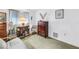 Spare bedroom featuring a wooden dresser, office chair and desk, and neutral-toned carpet at 9674 104Th Ave, Largo, FL 33773