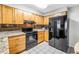Efficient kitchen design with light wood cabinets, modern appliances, and tile flooring at 9674 104Th Ave, Largo, FL 33773