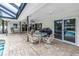 Screened in patio with brick pavers and patio furniture, leading to a private pool area at 9674 104Th Ave, Largo, FL 33773