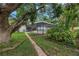 Enclosed pool area surrounded by lush landscaping, providing a private outdoor oasis at 9674 104Th Ave, Largo, FL 33773