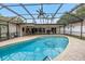 Relaxing screened-in pool featuring an open-air structure with patio furniture at 9674 104Th Ave, Largo, FL 33773