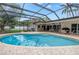 Inviting screened-in pool area with ample seating for entertaining and a clear blue swimming pool at 9674 104Th Ave, Largo, FL 33773