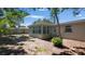 Backyard showcases a screened in back porch and window on a sunny day with a wooden fence at 10184 117Th Dr, Largo, FL 33773