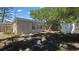 The backyard has a small building with glass windows and door next to a wooden fence and shed at 10184 117Th Dr, Largo, FL 33773
