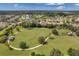 Aerial view showcasing a neighborhood community park with lush green space and walking paths at 10833 Breaking Rocks Dr, Tampa, FL 33647