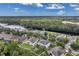 Aerial view of a Gathering-friendly neighborhood, featuring a beautiful waterfront and mature tree coverage at 10833 Breaking Rocks Dr, Tampa, FL 33647
