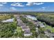 Aerial view of a serene lakeside community with tree-lined streets and well-maintained homes and landscaping at 10833 Breaking Rocks Dr, Tampa, FL 33647