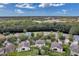 Aerial view of a community highlighting the homes surrounded by lush green space and waterway at 10833 Breaking Rocks Dr, Tampa, FL 33647