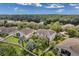 Aerial view of homes with well-manicured lawns and lush landscaping in a serene community setting at 10833 Breaking Rocks Dr, Tampa, FL 33647