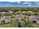 Spacious backyard featuring lush greenery, shade trees, a white fence, and well-maintained landscaping in a residential setting at 10833 Breaking Rocks Dr, Tampa, FL 33647