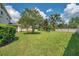 Spacious backyard with mature trees and lush lawn, perfect for outdoor enjoyment at 10833 Breaking Rocks Dr, Tampa, FL 33647