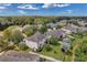 Backyard view with lush lawn, white fence, mature trees, and playground, perfect for outdoor enjoyment and Gathering activities at 10833 Breaking Rocks Dr, Tampa, FL 33647