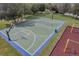 Aerial view of a community basketball court and playground in a well-maintained park setting at 10833 Breaking Rocks Dr, Tampa, FL 33647