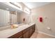Well-lit bathroom featuring a tile floor, shower/tub combo, and a large vanity with ample counter space at 10833 Breaking Rocks Dr, Tampa, FL 33647