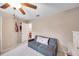 Bedroom with a gray sofa and view into an open closet at 10833 Breaking Rocks Dr, Tampa, FL 33647