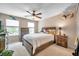 Inviting bedroom with a ceiling fan, two windows, and charming rustic furniture at 10833 Breaking Rocks Dr, Tampa, FL 33647