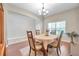 Cozy dining area showcasing hardwood floors and natural light through the window at 10833 Breaking Rocks Dr, Tampa, FL 33647