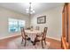 Warm dining room with a chandelier, window, and wood flooring at 10833 Breaking Rocks Dr, Tampa, FL 33647