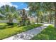 Inviting two-story home with lush lawn, garden beds, and a stone-accented facade at 10833 Breaking Rocks Dr, Tampa, FL 33647