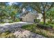 Beautiful home featuring a three-car garage, manicured lawn, and mature trees at 10833 Breaking Rocks Dr, Tampa, FL 33647