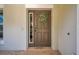Elegant front door with decorative wreath, sidelight window, and neutral exterior paint at 10833 Breaking Rocks Dr, Tampa, FL 33647