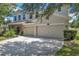 Attractive home with a three-car garage, neutral paint, and manicured landscaping at 10833 Breaking Rocks Dr, Tampa, FL 33647