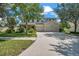 Beautiful two-story home featuring a three-car garage, a manicured lawn, and mature trees at 10833 Breaking Rocks Dr, Tampa, FL 33647