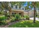Charming two-story home with a well-maintained front yard and a stone-accented porch at 10833 Breaking Rocks Dr, Tampa, FL 33647