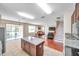 Kitchen with granite island open to the living room and sliding glass door to the lanai at 10833 Breaking Rocks Dr, Tampa, FL 33647