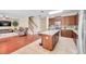 Open kitchen with stainless appliances, granite counters and island with seating at 10833 Breaking Rocks Dr, Tampa, FL 33647
