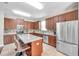 Kitchen features an island with bar seating, granite countertops, stainless steel appliances, and wood cabinets at 10833 Breaking Rocks Dr, Tampa, FL 33647