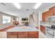 Spacious kitchen with granite island open to the living room and stairs to the second floor at 10833 Breaking Rocks Dr, Tampa, FL 33647
