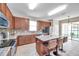 Open kitchen with granite countertops, tile flooring, stainless steel appliances and a center island with bar seating at 10833 Breaking Rocks Dr, Tampa, FL 33647
