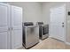 Laundry room with updated stainless steel washer and dryer at 10833 Breaking Rocks Dr, Tampa, FL 33647