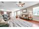 Open-concept living room featuring hardwood floors, natural light, and seamless flow into the kitchen at 10833 Breaking Rocks Dr, Tampa, FL 33647