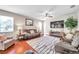 Comfortable living room with hardwood floors, a ceiling fan, and lots of natural light at 10833 Breaking Rocks Dr, Tampa, FL 33647