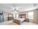 Primary bedroom featuring a ceiling fan, windows, and dresser set at 10833 Breaking Rocks Dr, Tampa, FL 33647