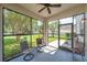 Screened-in patio with comfortable seating overlooking the backyard's lush lawn and playset at 10833 Breaking Rocks Dr, Tampa, FL 33647