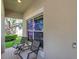 Cozy covered porch with two chairs, perfect for relaxing outdoors at 10833 Breaking Rocks Dr, Tampa, FL 33647
