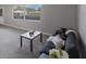 Living room with a large window, carpet floors, and a comfortable sofa with accent pillows at 11698 75Th Ave, Seminole, FL 33772