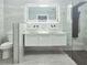 Sleek bathroom featuring a double sink vanity, floating cabinet, illuminated mirrors, and modern fixtures at 1178 Sultana St, Port Charlotte, FL 33952