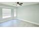 A spacious bedroom features tile floors, a ceiling fan, and lots of natural light at 1178 Sultana St, Port Charlotte, FL 33952