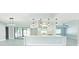 Open-concept kitchen with sleek white cabinetry, modern lighting, and a large island for entertaining at 1178 Sultana St, Port Charlotte, FL 33952