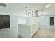 Modern kitchen with a large center island, stainless steel hood, and contemporary pendant lights at 1178 Sultana St, Port Charlotte, FL 33952