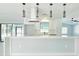 Bright, modern kitchen with white cabinets, pendant lighting, and a spacious breakfast bar at 1178 Sultana St, Port Charlotte, FL 33952