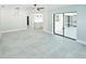 Modern living room with tiled floors, updated lighting, and sliding glass doors to the outdoor space at 1178 Sultana St, Port Charlotte, FL 33952